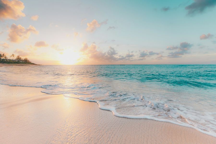 A quiet beach at sunset with gentle waves on the sand